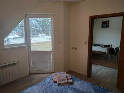 a living room with a large window and a blue rug at BOROVETS Royal Plaza - A405 in Borovets