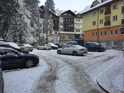 a group of cars parked on a snow covered street at BOROVETS Royal Plaza - A405 in Borovets