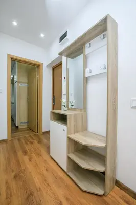 a kitchen with a wooden shelf in a room at Dream Park Apartment in Sandanski