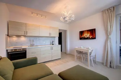 a kitchen with a couch and a table in a room at Pinewood Apartment Borovets in Borovets