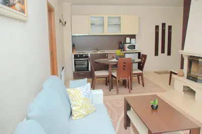 a living room with a couch and a dining room at Гранд Манастира Апартаменти 