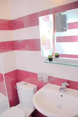 a bathroom with a white toilet and a sink at Гранд Манастира Апартаменти 