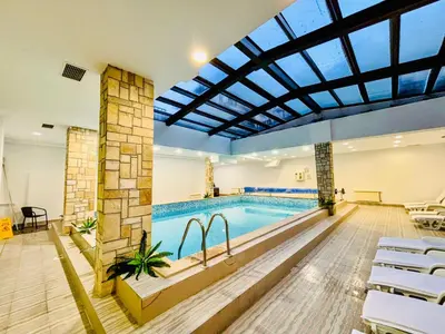 a large indoor pool with a large glass ceiling at Predela 1 - Studio 10 near Bansko Ski Lift in Bansko