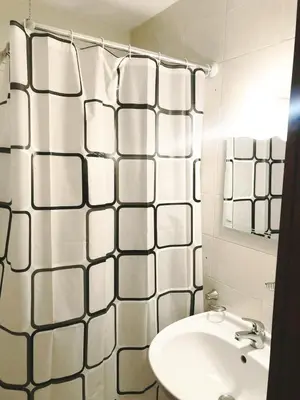 a white bathroom with a sink and a mirror at Predela 1 - Studio 10 near Bansko Ski Lift in Bansko