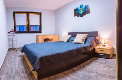 a bedroom with a bed with a blue comforter at Boutique 1-bedroom flat in the heart of the city in Plovdiv
