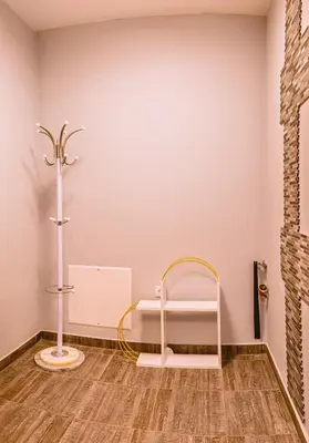 a room with a white wall and a shelf at Boutique 1-bedroom flat in the heart of the city in Plovdiv