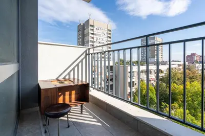 a desk on a balcony with a view of a city at Boutique 1-bedroom flat in the heart of the city in Plovdiv