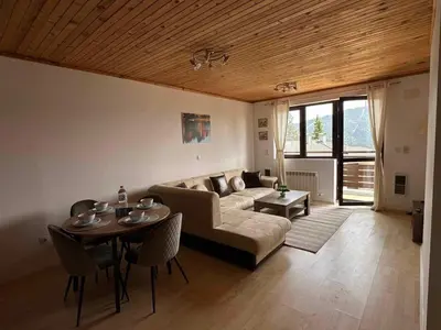 a living room with a couch and a table at Pamporovo Rhodopi Pearl Apartments - Private Apartments in Pamporovo