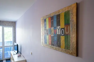a painting hanging on a wall in a room at Spacious apartment in the heart of Studentski grad in Sofia
