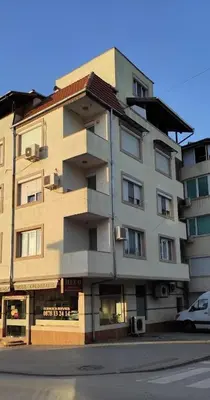 a tall building on a street with a car in front at BeLApartment in Petrich
