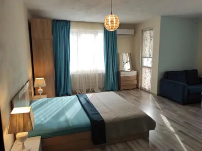 a bedroom with a blue bed and a blue couch at BeLApartment in Petrich