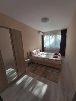 a small bedroom with a bed and a window at Apartment Krasi in Velingrad