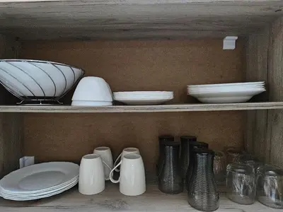 a shelf filled with plates and bowls and dishes at Apartment Krasi in Velingrad