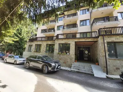 two cars parked in front of a building at Apartment Krasi in Velingrad