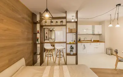 a room with a bed and a kitchen with white cabinets at Studio Talisman III in Sofia