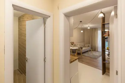 a hallway with a glass door leading to a living room at Studio Talisman III in Sofia