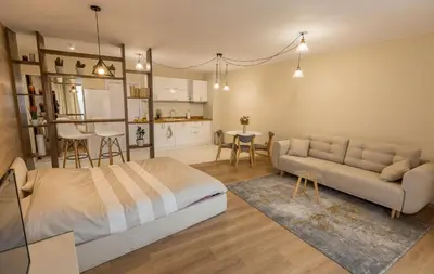 a bedroom with a bed and a couch and a table at Studio Talisman III in Sofia