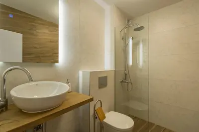 a bathroom with a sink and a shower and a toilet at Studio Talisman III in Sofia