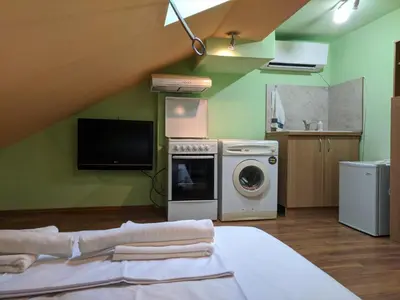 a kitchen with a washer and dryer in a room at Midtown Place Apartment Loft таванска стая с баня DORIS 2 in Plovdiv