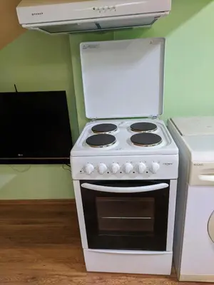 a white stove top oven sitting in a kitchen at Midtown Place Apartment Loft таванска стая с баня DORIS 2 in Plovdiv