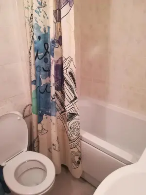 a bathroom with a toilet and a shower curtain at Апартамент-студио в Банско-Разлог,Aspen Golf- C206 in Bansko