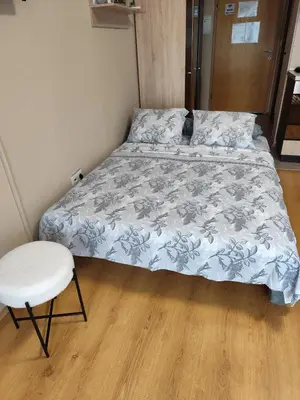 a small bedroom with a bed and a chair at Апартамент-студио в Банско-Разлог,Aspen Golf- C206 in Bansko