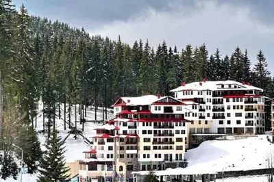 a large building on a snow covered mountain at Студио Пампорово Палас - Pamporovo Palace in Pamporovo