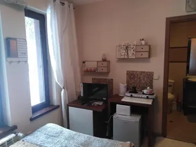 a bedroom with a desk with a computer on it at Ски студио Снежанка в Грийн лайф Пампорово in Pamporovo