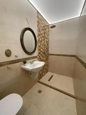 a bathroom with a sink and a toilet and a mirror at Guest House Amore in Sandanski