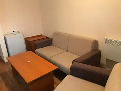 a small living room with a couch and a table at Ski Zone at Gondola, Perfect, Fast WiFi, Quiet, Warm in Bansko