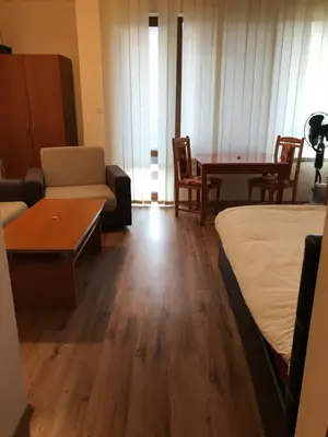 a room with a bed and a couch and a table at Ski Zone at Gondola, Perfect, Fast WiFi, Quiet, Warm in Bansko