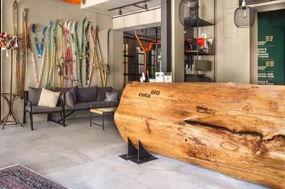 a large wooden bench in a room with skis at Hotel COTA1110 in Beli Iskar