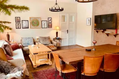 a living room with a table and a couch at Villa Aquila in Beli Iskar