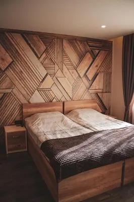 a bedroom with a wooden headboard with a wooden wall at Къща за гости Амая - Сандански in Sandanski