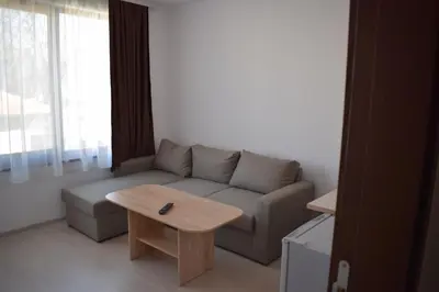 a living room with a couch and a coffee table at Къща за гости Шошови in Velingrad