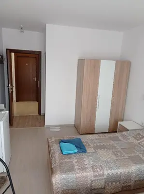 a bedroom with a bed with a blue towel on it at Къща за гости Шошови in Velingrad