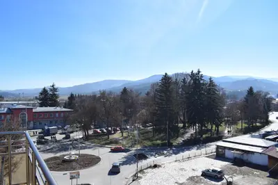 arial view of a city with cars parked in a parking lot at Къща за гости Шошови in Velingrad
