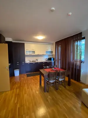 a kitchen and dining room with a table and chairs at K's Place Apartment Pravets Golf Resort in Pravets
