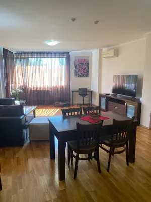 a living room with a table and chairs at K's Place Apartment Pravets Golf Resort in Pravets