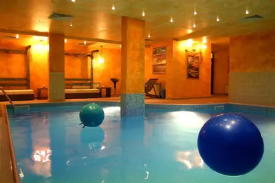 a swimming pool with two blue balloons in a building at Monastery 3 Apartments TMF in Pamporovo