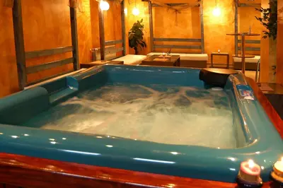 a large jacuzzi tub in a room at Monastery 3 Apartments TMF in Pamporovo