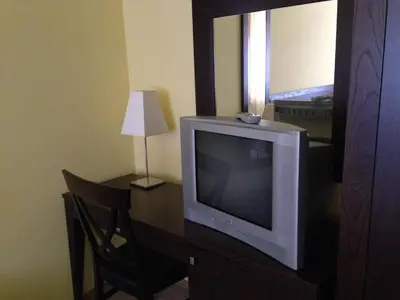 a television sitting on a desk in a room at Royal House Apartments TMF in Pamporovo