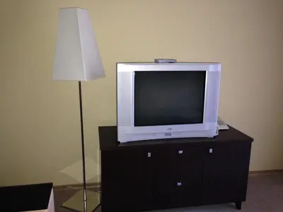 a tv sitting on top of a dresser with a lamp at Royal House Apartments TMF in Pamporovo