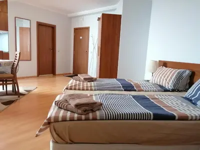 two beds sitting in a room with at Studio Villa Park 408 in Borovets