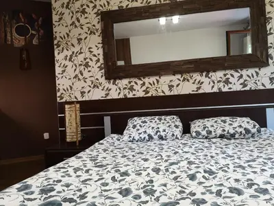 a bed with two pillows in a bedroom with a mirror at Studio 1 Iceberg Borovets in Borovets