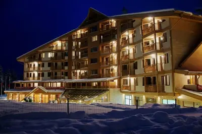 a large building in the snow at night at Studio 1 Iceberg Borovets in Borovets