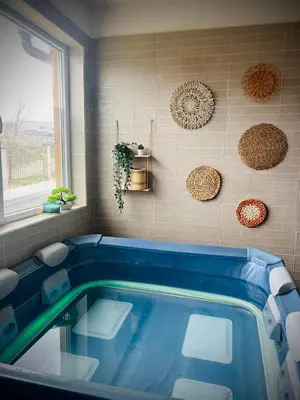 a blue tub in a bathroom with a window at AMAZING view, privacy and comfort - SPA Villa Krasi in Blagoevgrad