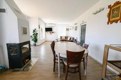 a dining room with a table and a wood stove at AMAZING view, privacy and comfort - SPA Villa Krasi in Blagoevgrad