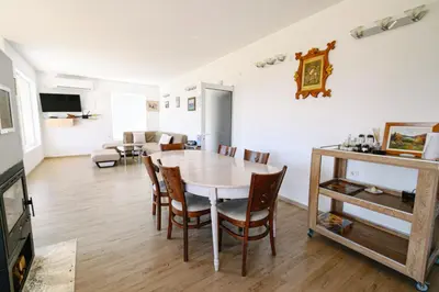 a dining room and living room with a table and chairs at AMAZING view, privacy and comfort - SPA Villa Krasi in Blagoevgrad
