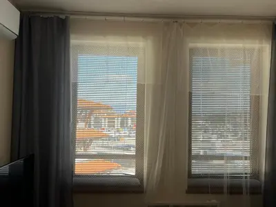 two windows with white curtains in a room at Ski Zone at Gondola, Warm and Cosy, WiFi, AC, Netflix, Perfect One Bedroom appartment, Beautiful View in Bansko